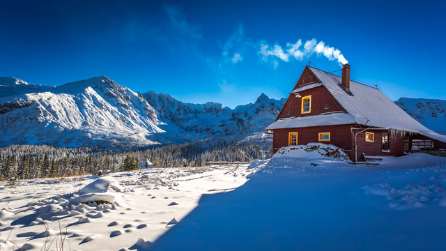 Warm cottage in winter mountain day