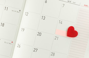 Calendar page with red heart on 14 February - Valentine day