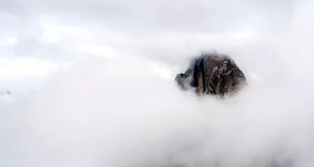 Papier Peint photo autocollant Half Dome Clouds and Fog Move in Covering Half Dome Yosemite