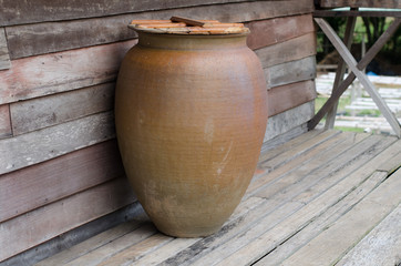 Glazed pottery for water storage on Thai wooden house terrace