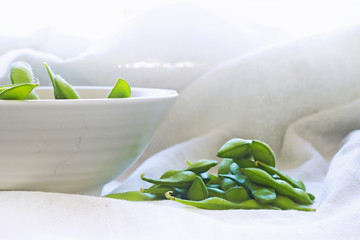 boiled green soybeans on fabric background