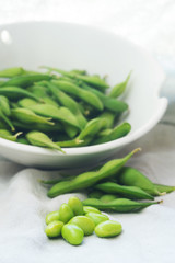 boiled green soybeans on fabric background