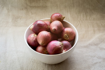 Red onions on fabric background