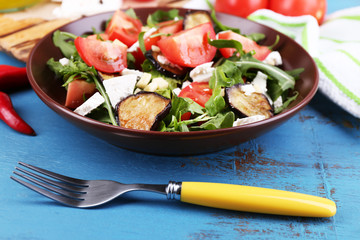 Eggplant salad with tomatoes, arugula and feta cheese,