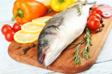 Fresh raw fish and food ingredients on table