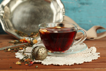 Beautiful vintage composition with herbal tea, on wooden table