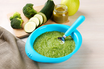 Fresh baby food in bowl with spoon