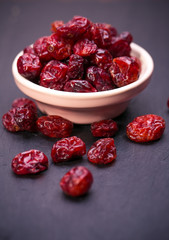dried cranberries in a wooden spoon.fruit full of vitamin c. 