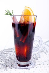 Glass of hot mulled wine with piece of orange