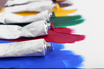 Colorful paint strokes on sheet of paper background