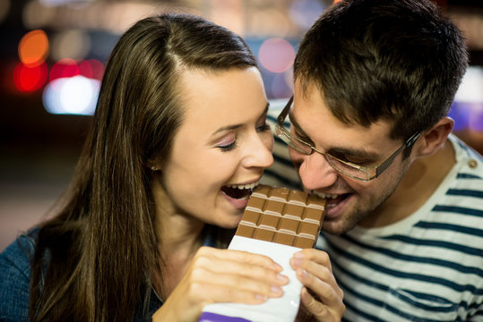 Couple eating chocolate on date