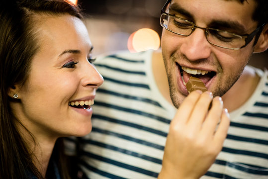 Couple Eating Chocolate On Date At Night