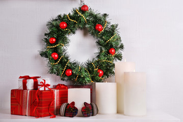 Christmas decoration with wreath, candles and present boxes