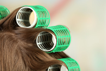 Long female hair during hair dressing with curler, close-up,