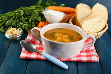 Composition with carrot soup, ingredients and herbs