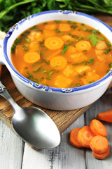 Composition with carrot soup, ingredients and herbs