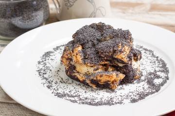 Poppy seed bread on white plate. Hungarian traditional dessert.