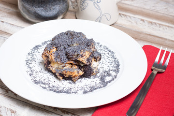 Poppy seed dumps on white plate. Hungarian traditional dessert.