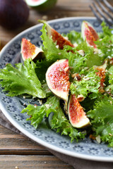 Fresh delicious salad with figs and lettuce on a plate