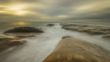Seascape with long exposure on the rocks.  Black and white.