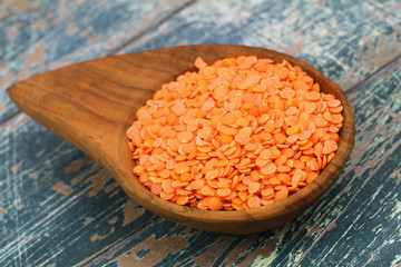 Uncooked red lentils in bamboo dish, closeup