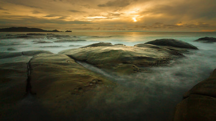 Seascape sunset with long exposure on the rocks.