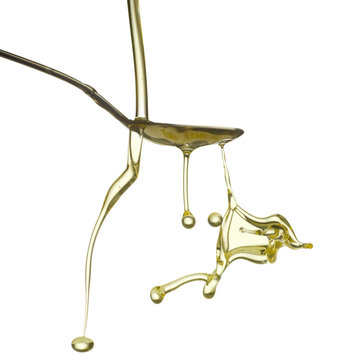 Pouring oil splash. Isolated on white background.