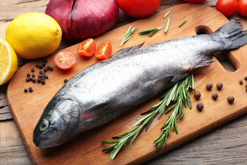 Fresh raw fish and food ingredients on table