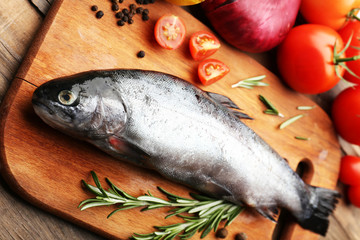 Fresh raw fish and food ingredients on table