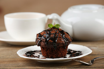 Yummy chocolate cupcake on table