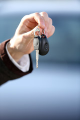 Businessman holding car key outdoors