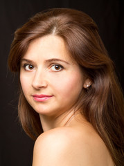 Obraz premium Young woman with long beautiful hair posing in studio.