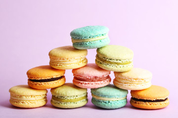 Assortment of gentle colorful macaroons on color background