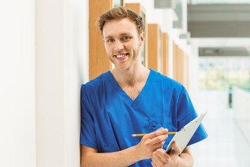 Medical student smiling at camera in hallway