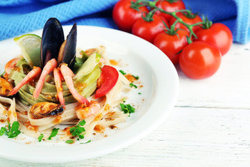 Tasty pasta with shrimps, mussels and tomatoes