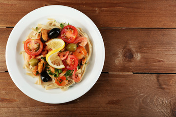 Tasty pasta with shrimps, mussels, black olives and tomato