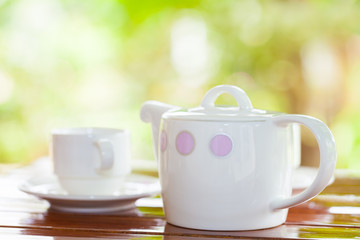 White porcelain set for tea or coffee on wooden table
