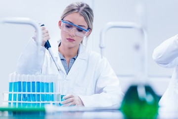 Science student using pipette in the lab