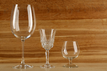 Empty goblets on wooden background