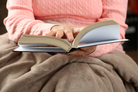 Old woman reading Bible, closeup