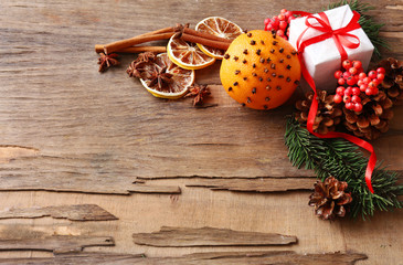 Orange with present box, spices, slices of dried lemon and