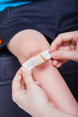 Child knee with a plaster (for wounds) and bruise
