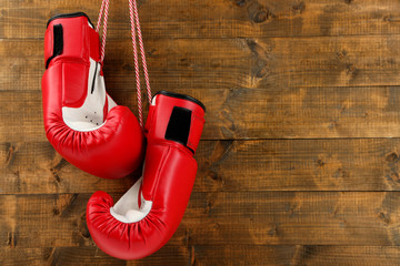 Pair of boxing gloves on wooden planks background