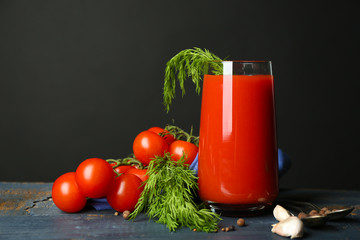 Glass of tasty tomato juice and fresh tomatoes