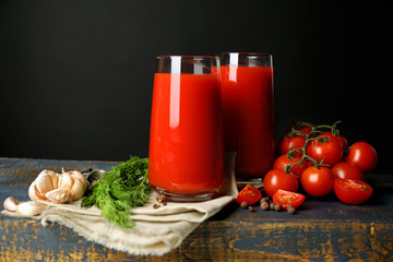 Glasses of tasty tomato juice and fresh tomatoes