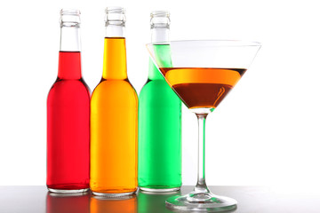 Colorful alcoholic beverages in glassware isolated on white