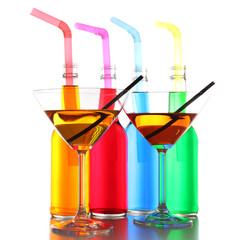 Colorful alcoholic beverages in glassware isolated on white