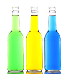 Colorful alcoholic beverages in glass bottles isolated on white