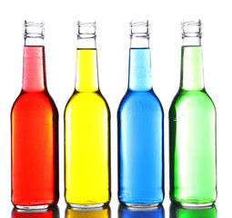 Colorful alcoholic beverages in glass bottles isolated on white