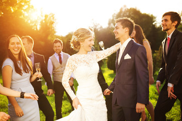 Newlyweds with guest on their garden party